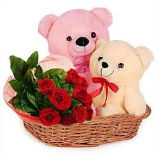 two teddy bears with 12 roses in same basket