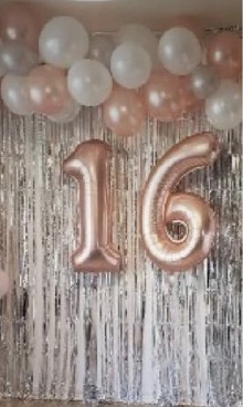 Pink white Balloons line on top with double digit balloon and silver streamers decoration