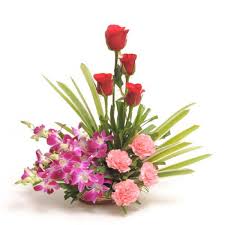 A basket of roses, carnations and orchids