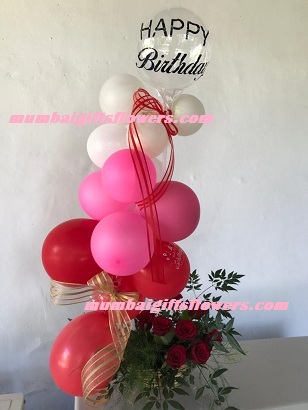 Pink red white balloons arrangement with roses and happy birthday balloon