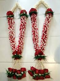 Wedding ceremony ritual traditional jaimala with fresh red roses for bride and groom