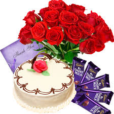 A bouquet of 12 red roses 1/2 kg chocolate truffle cake 4 silk chocolates a card