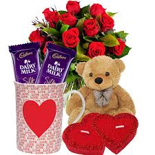 A bouquet of 15 red roses 2 chocolates and a teddy bear with coffee mug and 2 cushion hearts