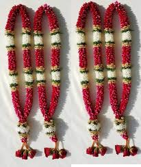 Wedding ceremony ritual traditional jaimala with fresh red roses for bride and groom