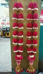 2 garlands with red and white flowers and beads